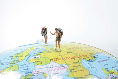 small traveler figures with backpack standing on earthの写真素材