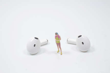 Travel, Music and hobby concept. A miniature figure sitting and readingの写真素材