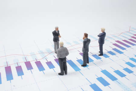 a mini Businessman thinking with project for investmentの写真素材