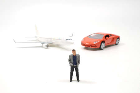 the Mini people, businessman and car airplane on white boardの写真素材