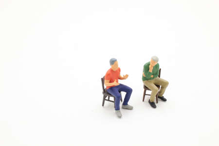 the mini of figure on chairs talking