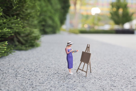 the mini of figure at woman painting in the parkの写真素材