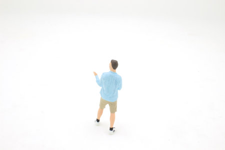 a mini young figure with beard pointing away