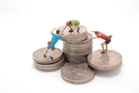 climbers team climbing on stack of coinsの写真素材