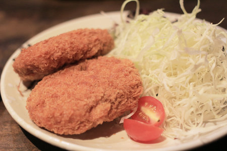 Japanese style deep fried oysters on brown wooden backgroundの写真素材