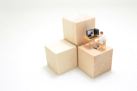 a mini figure in the home office on cubeの写真素材