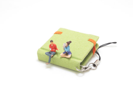 the lover figure sit on the bookの写真素材