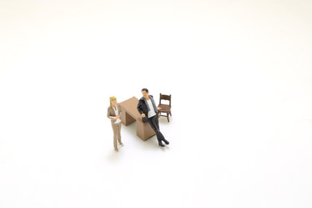 a Business executive with a secretary at his deskの写真素材