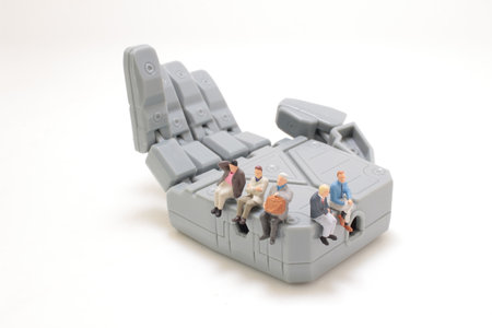 the figure sits on the big robot handの写真素材