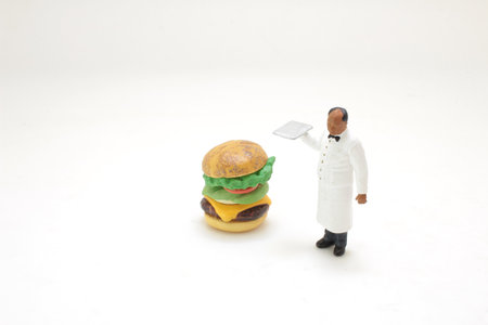 a figure of waiter with homemade burgerの写真素材