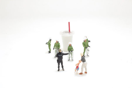 police officer stops a kid from reaching soft drinkの写真素材