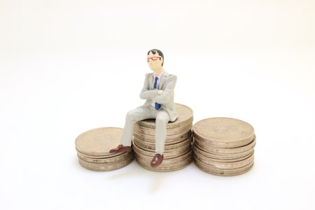 the Business man siting and chillin on coinsの写真素材