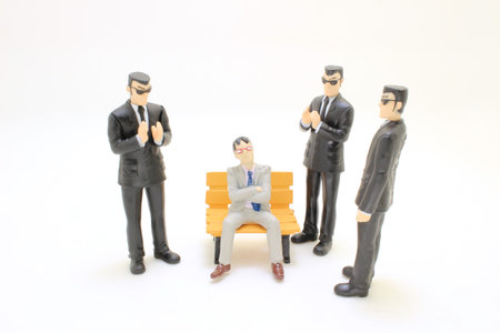 a figure businessman sitting on park benchの写真素材