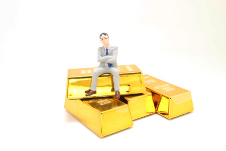 mini of Figure businessman sitting on gold barの写真素材