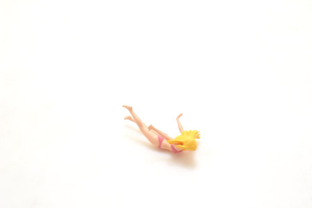 Small Figurine of a Person on a White Background
