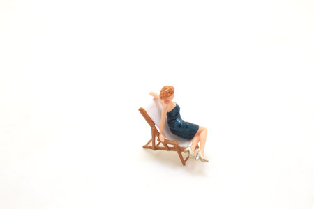 a Tiny figurine of a woman in elegant dress on white.の写真素材