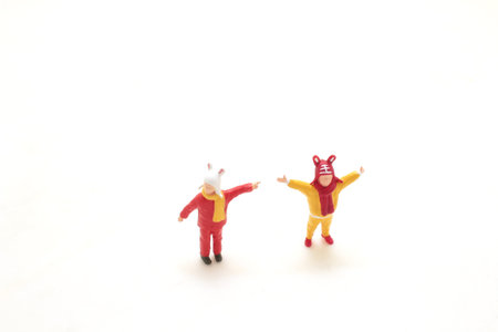 a Tiny figures dressed as animals celebrating on white