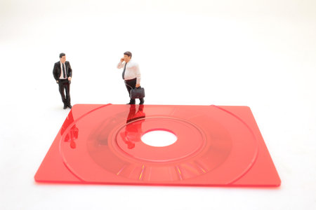 a Business figurine standing on a compact disk
