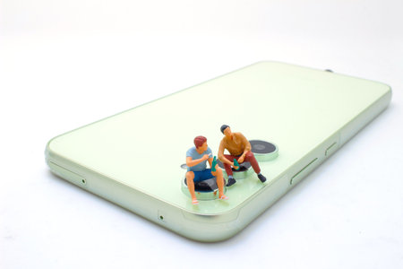 friends having fun while toasting with beer on mobile phoneの写真素材