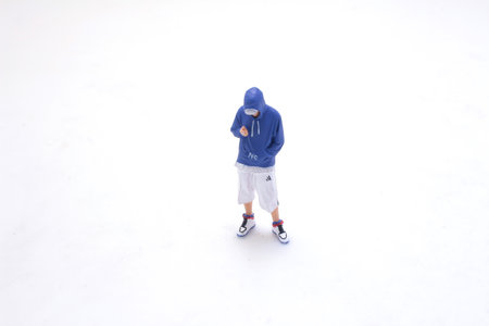 man in jeans and jacket hood standing lookingの写真素材