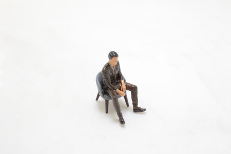 a figure man site on the chairの写真素材