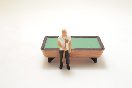 figurines engaged in a billiards game, representing leisure activities and social interaction