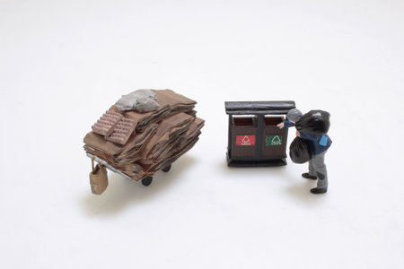 Miniature figures depicting a scene of recycling and waste collection.