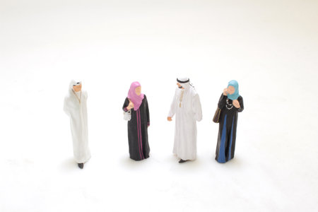 miniature figures in traditional Middle Eastern attire are engaged in a conversationの写真素材