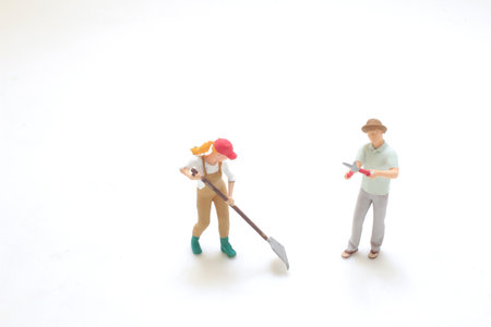 figurines depicting gardeners engaged in outdoor activities with toolの写真素材