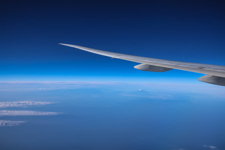 Dec 3 2024 wing flying at high altitude, with clear skies and fascinating cloudの写真素材
