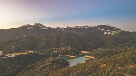 Jan 12 2025 Serene aerial view of a tranquil lake amidst lush forested hillsの写真素材