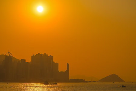 Jan 19 2025 silhouette of a bustling city skyline against a glowing orangeの写真素材