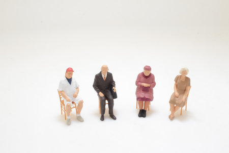Miniature figurines of individuals seated in a circle, portraying