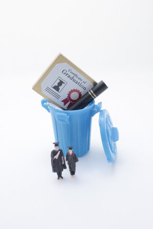concept visualizing the perceived value of education through miniature figuresの写真素材