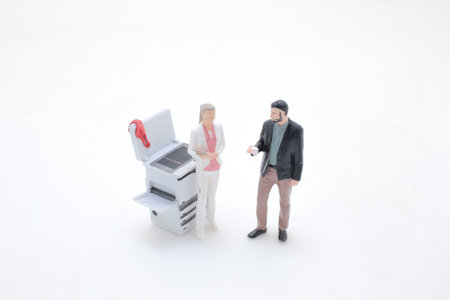 Depicting a business-themed scene with two figurine peopleの写真素材