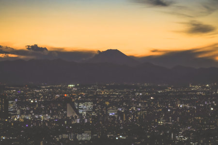 Dec 6 2024 Beautiful city skyline illuminated by lights at twilight, with a stunning goldenの写真素材
