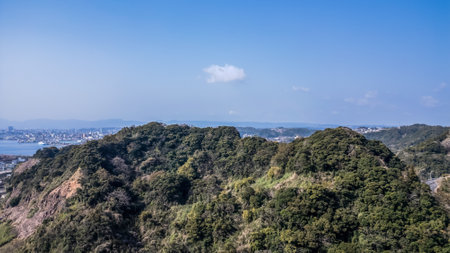 March 23 2025 breathtaking aerial view of a lush green hill by the coastの写真素材