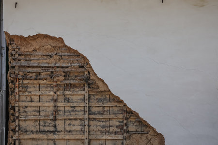 March 23 2025 wooden framework and deteriorated plaster of a damaged wall,の写真素材