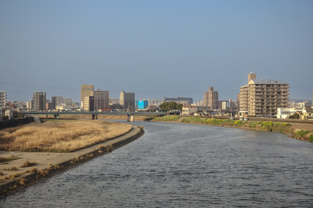 An urban view featuring a flowing river flanked by modern buildingsの写真素材