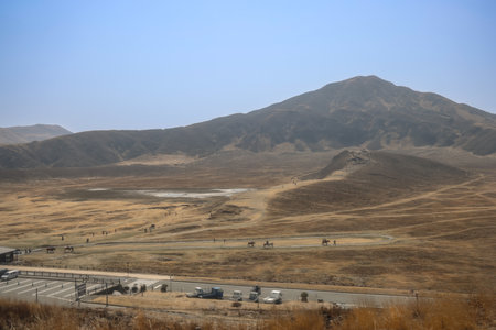 Vast dry plains stretching toward rolling hills under a bright,の写真素材