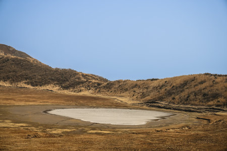 A tranquil landscape showcasing a dry lake in a valleyの写真素材