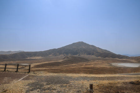 Vast dry plains stretching toward rolling hills under a bright,の写真素材