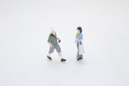 group of three miniature figurines depicting individuals walking