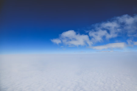 clouds stretching across the horizon under a vibrant blue sky,