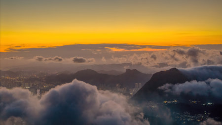Vivid sunset illuminating the sky above cityscape and hills,の写真素材