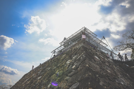 A historic castle atop a stone foundation undergoing renovation,の写真素材