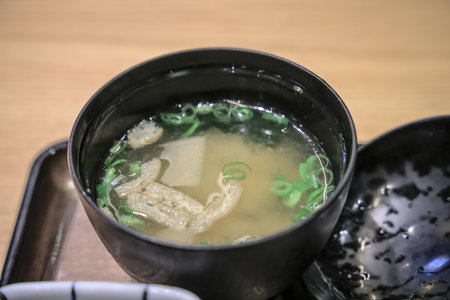 Delicious Japanese miso soup served in a black bowl,