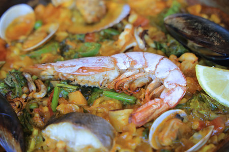 paella with shrimp, clams, and squid atop rice and vegetables