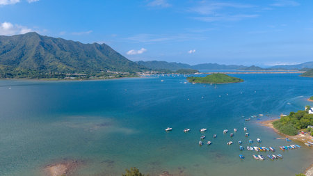 showcasing a tranquil coastline bordered by lush green mountainsの写真素材