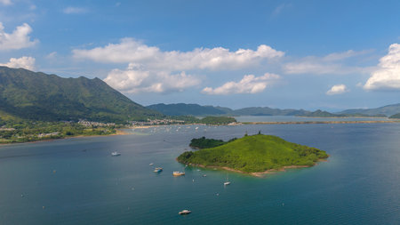 showcasing a tranquil coastline bordered by lush green mountainsの写真素材